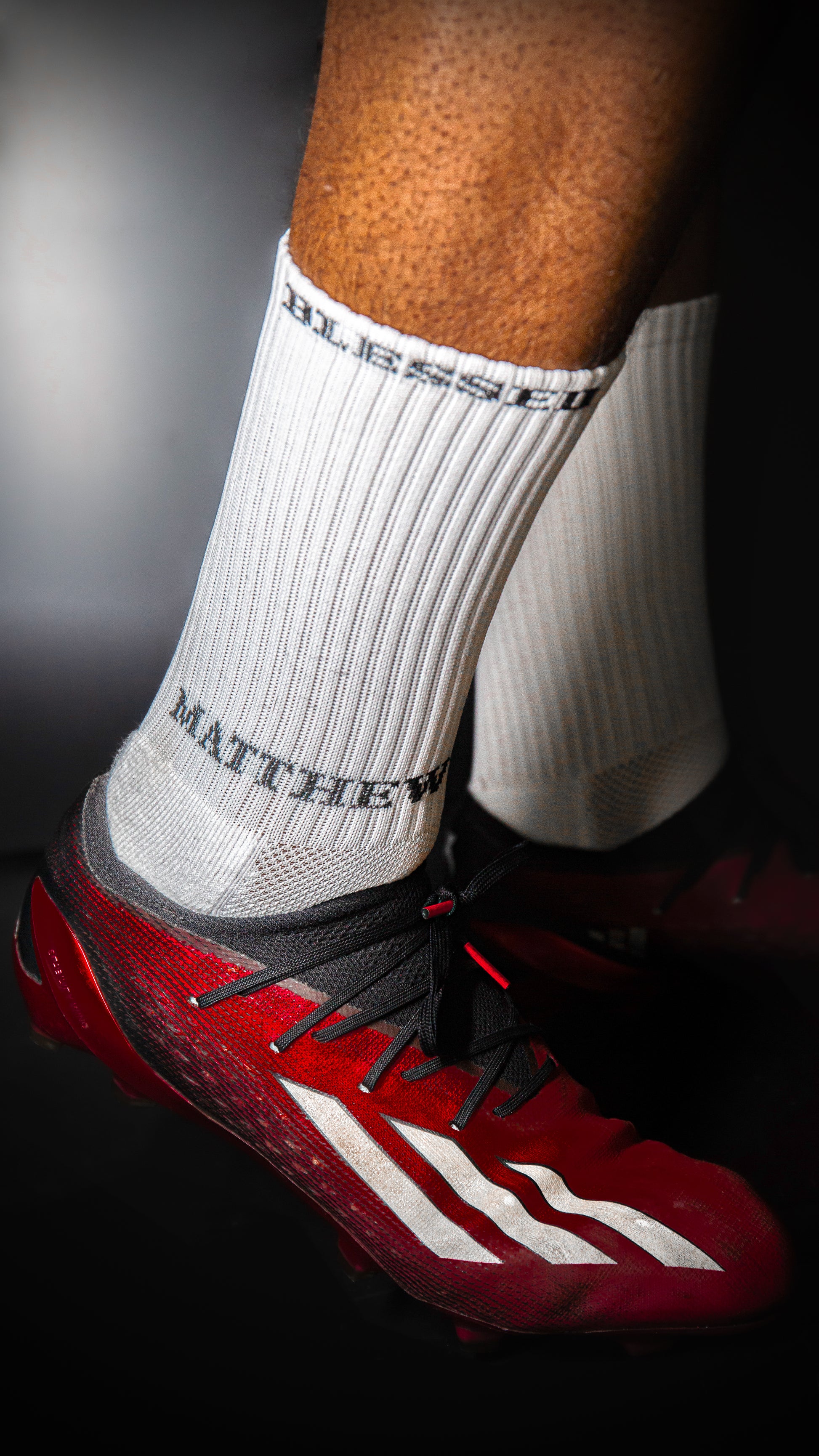 Athletic socks with grip soles and red soccer cleats
