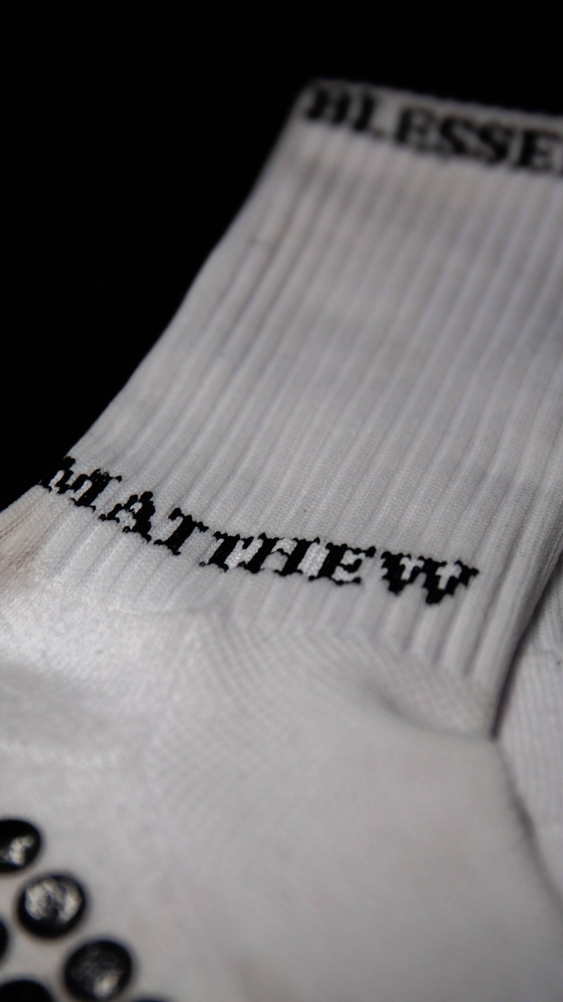 White performance socks with grip dots and biblical text for sports accessories