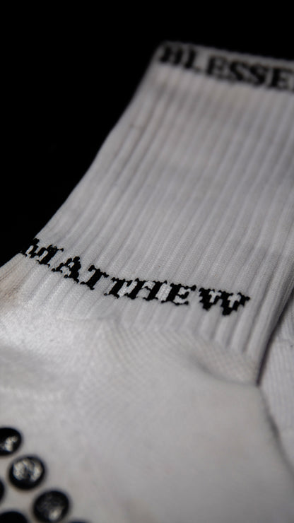 White performance socks with grip dots and biblical text for sports accessories